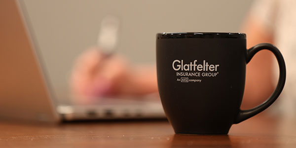 A close-up of a Glatfelter Insurance Group branded coffee mug