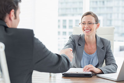 women shaking person's hand